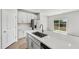 Modern kitchen featuring a large island with a sink and stainless steel appliances at 591 White Birch Ln, Angier, NC 27501