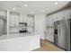 Kitchen with stainless steel appliances, island, and white cabinets at 591 White Birch Ln, Angier, NC 27501