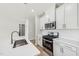 Spacious kitchen with stainless steel appliances, backsplash, and sink at 591 White Birch Ln, Angier, NC 27501