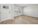 Bright living room with hardwood floors, a white door, and natural light streaming through the windows at 591 White Birch Ln, Angier, NC 27501