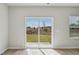 An empty room with wood floors and sliding glass doors leading to the outside at 591 White Birch Ln, Angier, NC 27501