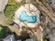 Aerial view of a community pool surrounded by trees and landscaping at 6001 Winterpointe Ln # 204, Raleigh, NC 27606