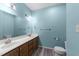 Bathroom with double vanity, tile floors, and blue walls at 6001 Winterpointe Ln # 204, Raleigh, NC 27606