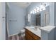 Bright bathroom with modern vanity, tile floors, and a large mirror at 6001 Winterpointe Ln # 204, Raleigh, NC 27606