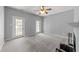 Spacious bedroom with neutral carpet, two doors to the outside and a corner fireplace at 6001 Winterpointe Ln # 204, Raleigh, NC 27606