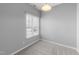 Bedroom with neutral carpet and light gray walls, featuring a window with blinds at 6001 Winterpointe Ln # 204, Raleigh, NC 27606