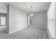 Dining room with carpet flooring, gray walls, and a modern hanging light fixture at 6001 Winterpointe Ln # 204, Raleigh, NC 27606