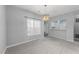 Bright dining room featuring a modern chandelier and an open view into the kitchen at 6001 Winterpointe Ln # 204, Raleigh, NC 27606