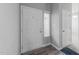 Entryway with a white door, light gray walls, and wood-look flooring at 6001 Winterpointe Ln # 204, Raleigh, NC 27606