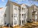 Rear exterior of a multi-level condo with balconies, windows, and foliage at 6001 Winterpointe Ln # 204, Raleigh, NC 27606