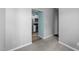 Hallway leading to a kitchen area with modern appliances and white cabinets at 6001 Winterpointe Ln # 204, Raleigh, NC 27606