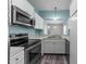 Kitchen featuring modern appliances, white cabinets, and a view to the dining area at 6001 Winterpointe Ln # 204, Raleigh, NC 27606