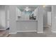 Bright kitchen with white cabinets, stainless steel appliances, and an open breakfast bar at 6001 Winterpointe Ln # 204, Raleigh, NC 27606