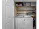 Laundry closet with a side-by-side washer and dryer on shelves at 6001 Winterpointe Ln # 204, Raleigh, NC 27606