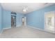 Main bedroom with blue walls, plush carpet, a ceiling fan and a door to the outside at 6001 Winterpointe Ln # 204, Raleigh, NC 27606