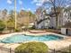 Large community pool surrounded by greenery, with a multi-story building in the background at 6001 Winterpointe Ln # 204, Raleigh, NC 27606