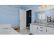 Bright bathroom featuring a double sink vanity with granite countertop and tub at 6089 Joe Trail Ct, Mebane, NC 27302