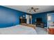 Cozy bedroom with a ceiling fan and light wood floors at 6089 Joe Trail Ct, Mebane, NC 27302