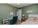 Comfortable bedroom with desk, bright blue accent, and view to the hallway at 6089 Joe Trail Ct, Mebane, NC 27302