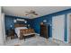 Stylish bedroom boasts a wooden bed frame, accent wall, and rustic decor at 6089 Joe Trail Ct, Mebane, NC 27302
