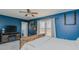 Comfortable bedroom with rustic wood bed frame, ceiling fan, and light-filled window views at 6089 Joe Trail Ct, Mebane, NC 27302