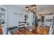 Rustic dining area with wood table, chairs, and industrial-style lighting at 6089 Joe Trail Ct, Mebane, NC 27302