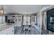A transitional kitchen flows into a dining area with a wooden table and stainless fridge at 6089 Joe Trail Ct, Mebane, NC 27302