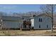 Exterior view of home with a rear deck, lush yard, and private setting at 6089 Joe Trail Ct, Mebane, NC 27302
