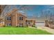 Charming brick home featuring a well-manicured lawn and an attached two car garage at 6089 Joe Trail Ct, Mebane, NC 27302