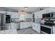 Bright kitchen featuring white cabinets, stainless steel appliances, and granite countertops at 6089 Joe Trail Ct, Mebane, NC 27302