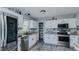 Modern kitchen boasts stainless steel appliances, white cabinets and stone countertops at 6089 Joe Trail Ct, Mebane, NC 27302