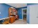 Basement office space with wooden desk, bookshelf, and open doorway at 6089 Joe Trail Ct, Mebane, NC 27302
