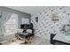 Bright office featuring light wood floors, floral wallpaper, natural light and a gray accent wall at 6089 Joe Trail Ct, Mebane, NC 27302