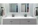 The renovated bathroom features a double vanity, modern mirrors, and stylish light-blue walls at 628 Woods Mill Cir, Wake Forest, NC 27587