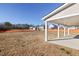 Wide view of backyard featuring covered patio and level land at 65 Hickory Run Ln, Franklinton, NC 27525