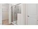 Modern bathroom with tiled shower and glass door, with a peek into the closet area at 65 Hickory Run Ln, Franklinton, NC 27525