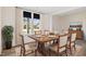 Bright dining room features wood table and chairs, large window with curtains, and hardwood floors at 65 Hickory Run Ln, Franklinton, NC 27525