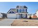 Charming two-story home with blue siding, white trim, and an attached two-car garage at 65 Hickory Run Ln, Franklinton, NC 27525