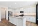 Modern kitchen boasts white cabinets, granite countertops, stainless steel appliances, and a large center island at 65 Hickory Run Ln, Franklinton, NC 27525