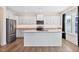 Bright kitchen featuring white cabinets, granite countertops, stainless steel appliances, and a central island at 65 Hickory Run Ln, Franklinton, NC 27525