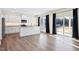 Open kitchen featuring stainless steel appliances, white cabinetry, granite counters and hardwood floors at 65 Hickory Run Ln, Franklinton, NC 27525