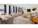 Open-concept living room with modern furniture, hard wood flooring, and lots of windows at 65 Hickory Run Ln, Franklinton, NC 27525