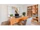 Home office space featuring a wooden desk, chair, bookcase, and french doors at 65 Hickory Run Ln, Franklinton, NC 27525
