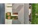 Aerial view of a well-maintained townhome featuring landscaped lawn, sidewalk, and attached garage at 653 Huntingdon St, Elon, NC 27244