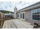 Inviting back deck featuring a classic chimney, pristine white French doors, and durable vinyl siding at 653 Huntingdon St, Elon, NC 27244