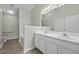 Well-lit bathroom with a double sink vanity, a large mirror, and a separate toilet area at 653 Huntingdon St, Elon, NC 27244