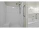 Bathroom features a walk-in shower with grab bar and separate soaking tub for accessibility and relaxation at 653 Huntingdon St, Elon, NC 27244
