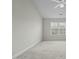 Neutral bedroom with vaulted ceiling and natural light from the window at 653 Huntingdon St, Elon, NC 27244
