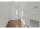 Bright foyer featuring hardwood floors, a white front door, and a glimpse into an adjacent room at 653 Huntingdon St, Elon, NC 27244