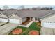 Charming townhome featuring a manicured lawn, attached garage, and inviting front entryway at 653 Huntingdon St, Elon, NC 27244